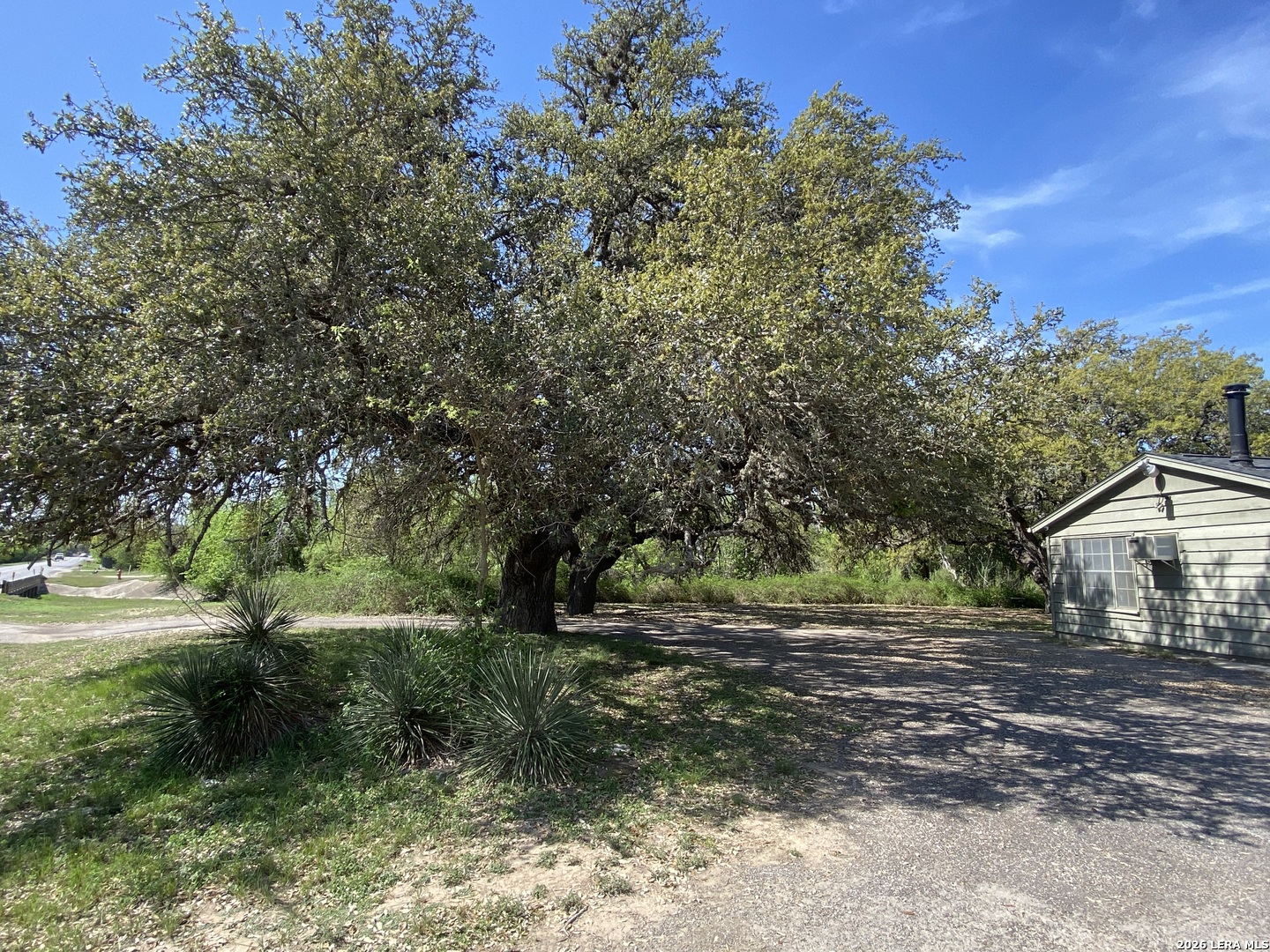 300 Ave M Hondo, TX 78861 - Photo 3 of 37 a backyard of a house with a yard and outdoor seating