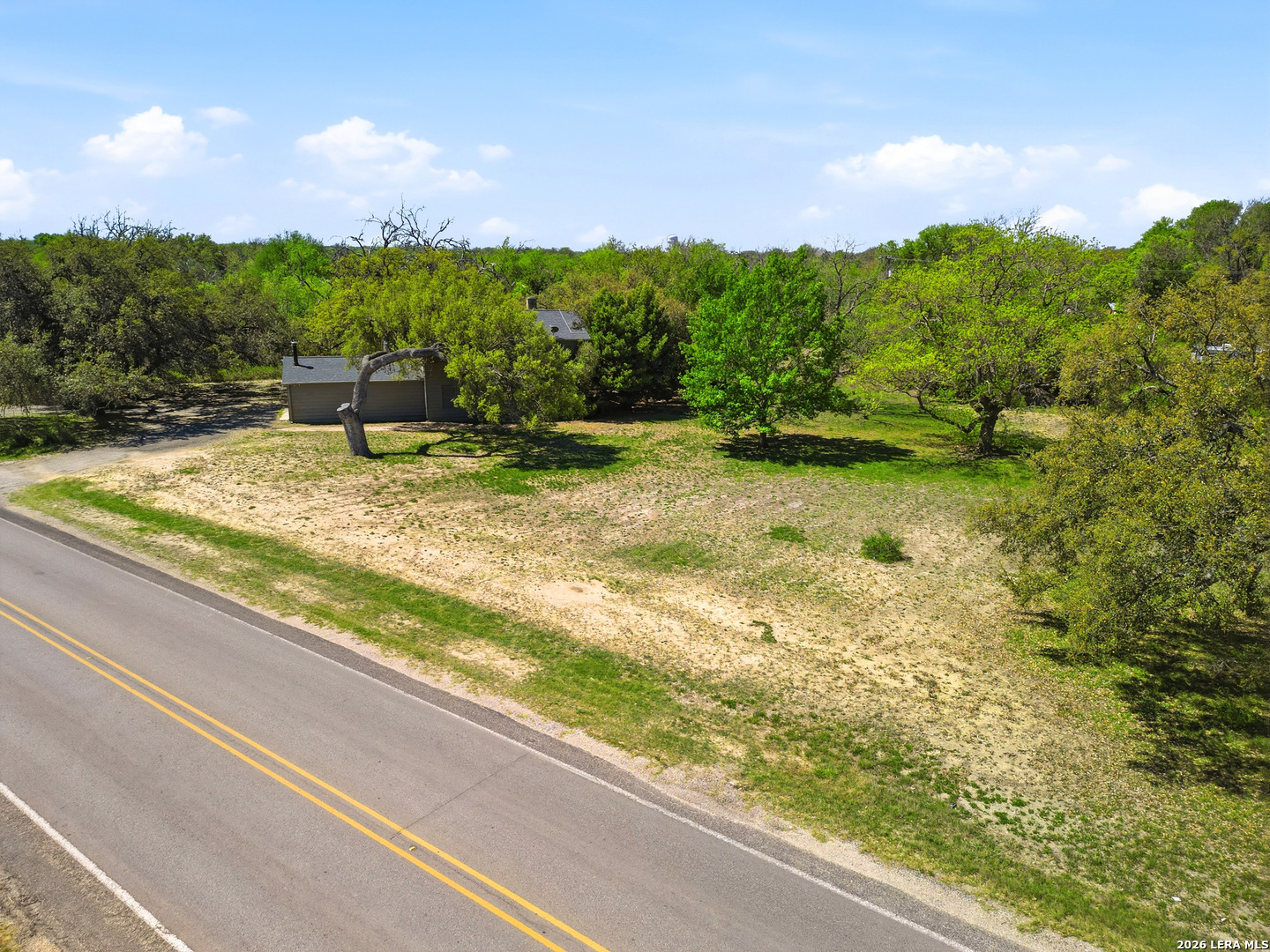 300 Ave M Hondo, TX 78861 - Photo 33 of 37 a view of a swimming pool with a yard and large tree