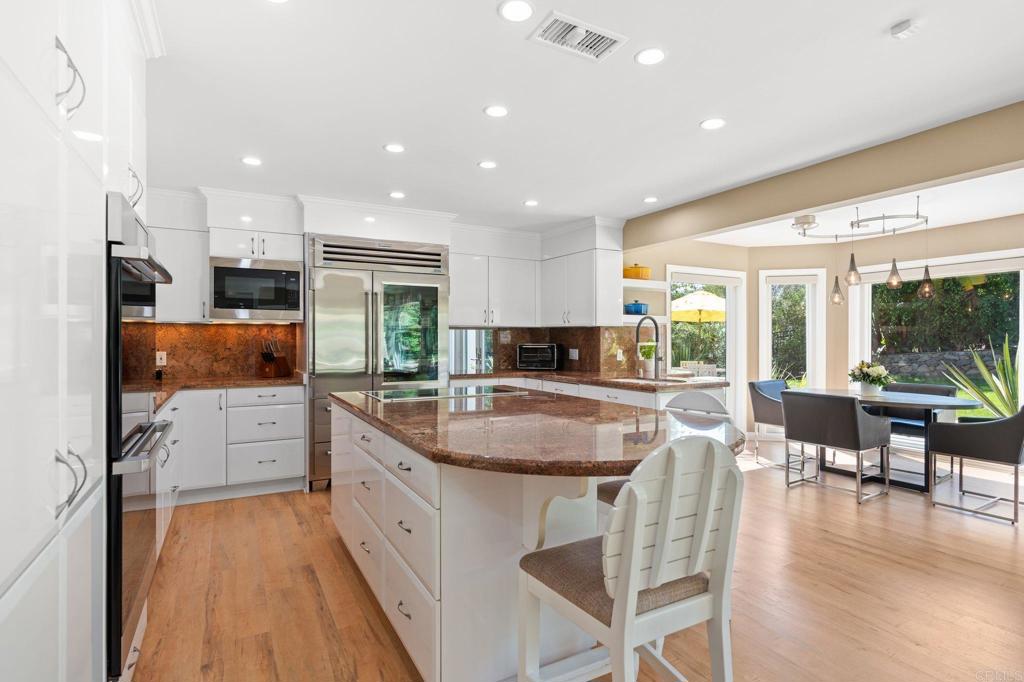 1229 Caminito Graciela Encinitas, CA 92024 - Photo 12 of 34 a kitchen with white cabinets and sink