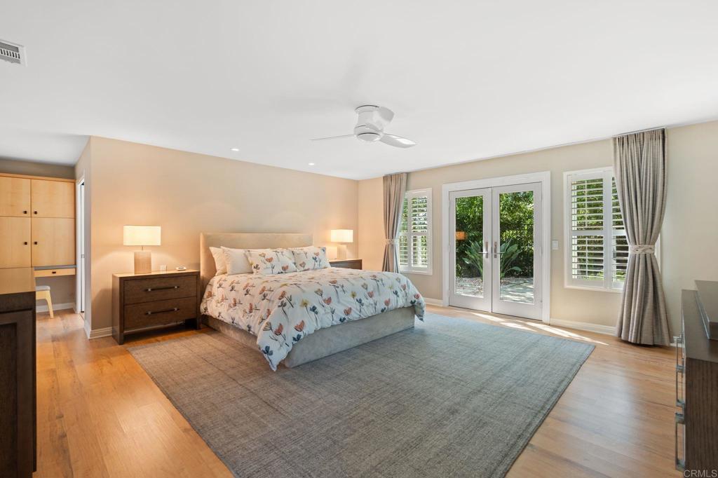 1229 Caminito Graciela Encinitas, CA 92024 - Photo 16 of 34 a bedroom with a large bed and a couch