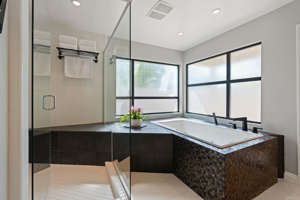 1229 Caminito Graciela Encinitas, CA 92024 - Photo 19 of 34 a bathroom with a sink and a large mirror