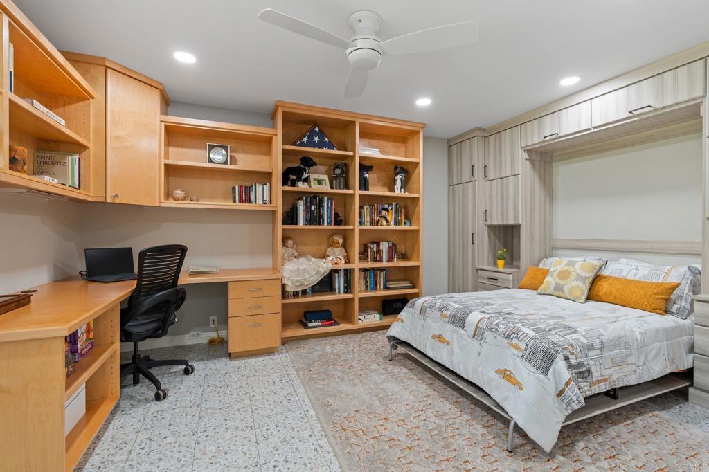 1229 Caminito Graciela Encinitas, CA 92024 - Photo 23 of 34 a bedroom with a bed and a bookshelf