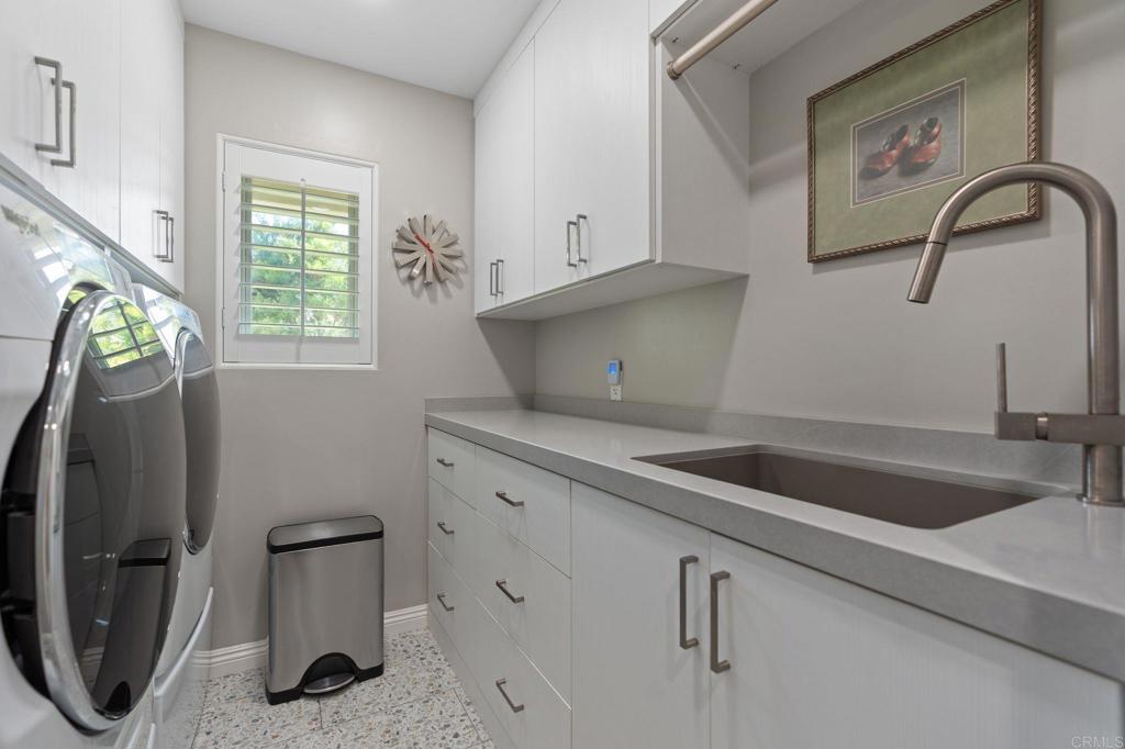 1229 Caminito Graciela Encinitas, CA 92024 - Photo 25 of 34 a kitchen with a refrigerator and a sink