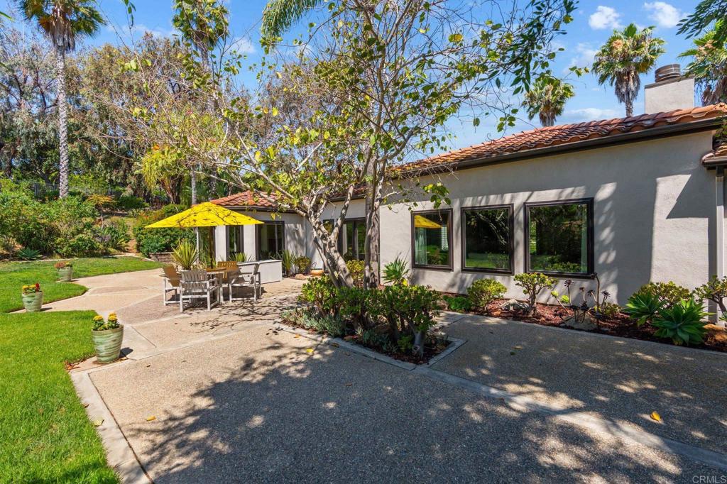 1229 Caminito Graciela Encinitas, CA 92024 - Photo 28 of 34 a view of a patio with table and chairs under an umbrella
