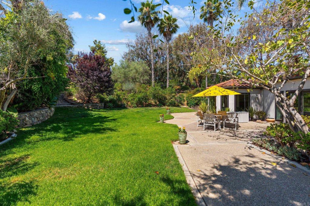 1229 Caminito Graciela Encinitas, CA 92024 - Photo 29 of 34 a view of a swimming pool with table and chairs under an umbrella