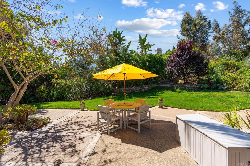 1229 Caminito Graciela Encinitas, CA 92024 - Photo 30 of 34 a view of a table and chairs under an umbrella