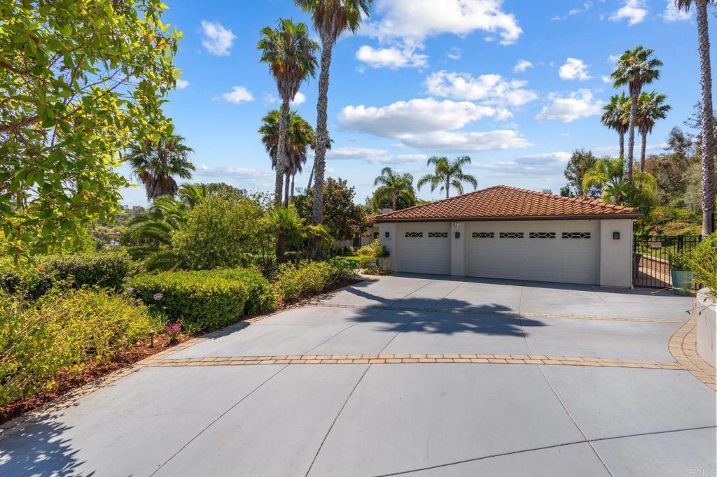 1229 Caminito Graciela Encinitas, CA 92024 - Photo 4 of 34 a front view of a house with a yard and trees