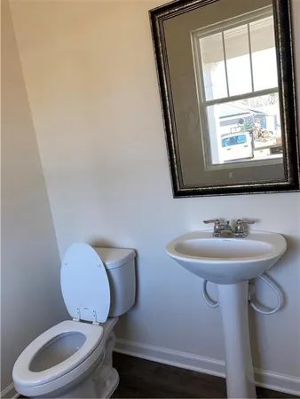 a bathroom with a toilet sink and mirror