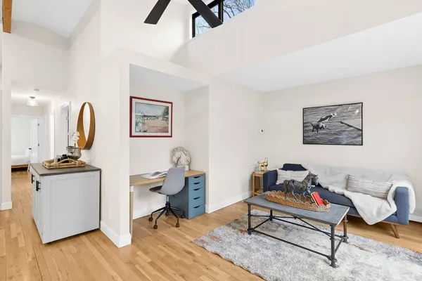 a living room with furniture and wooden floor