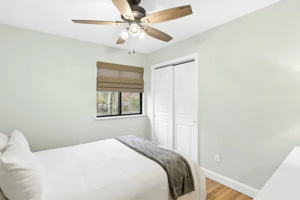 a bedroom with a bed and a chandelier
