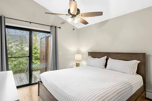 a bedroom with a large bed and a large window