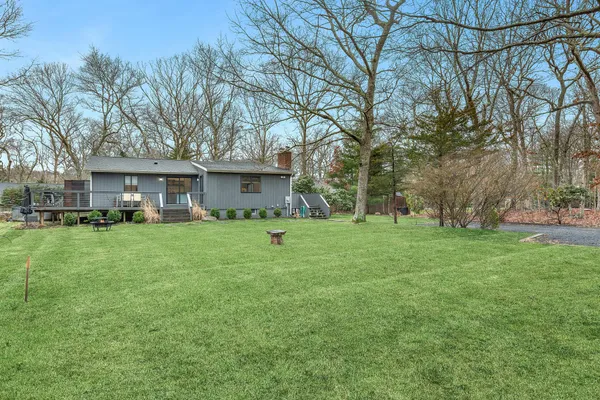 a front view of a house with a yard and trees