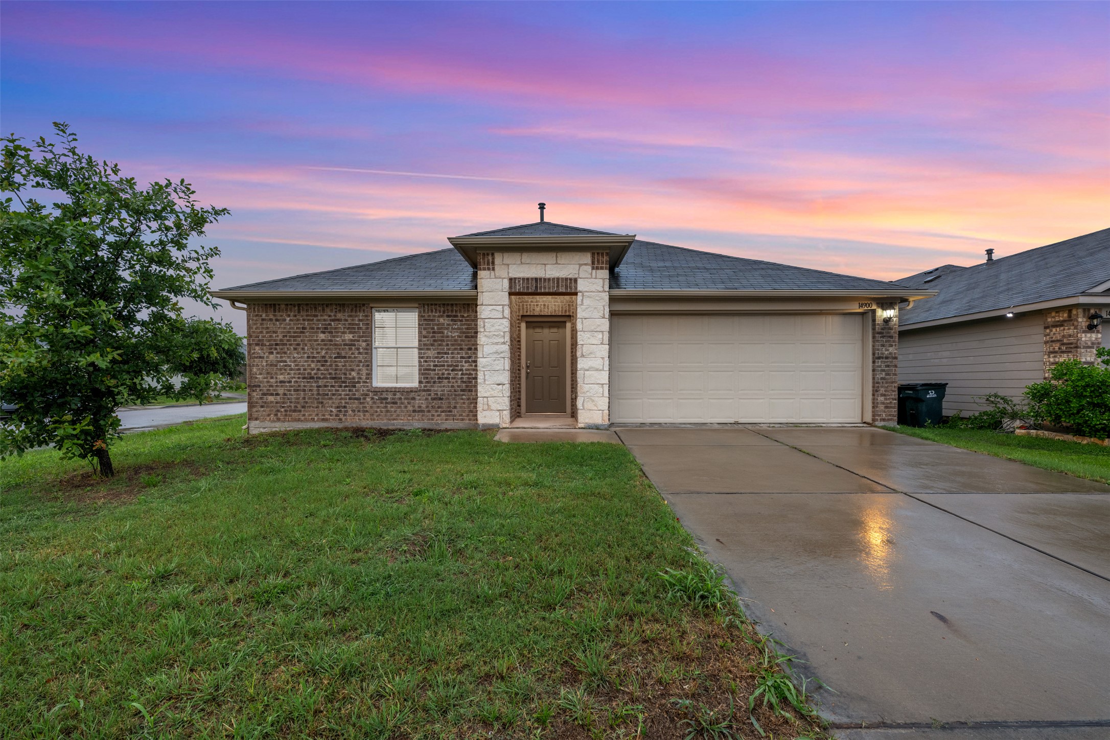 14900 Retha Pass Austin, TX 78725 - Photo 1 of 39 Brick and stone facade residence featuring a dark shingle roof and an attached two-car garage