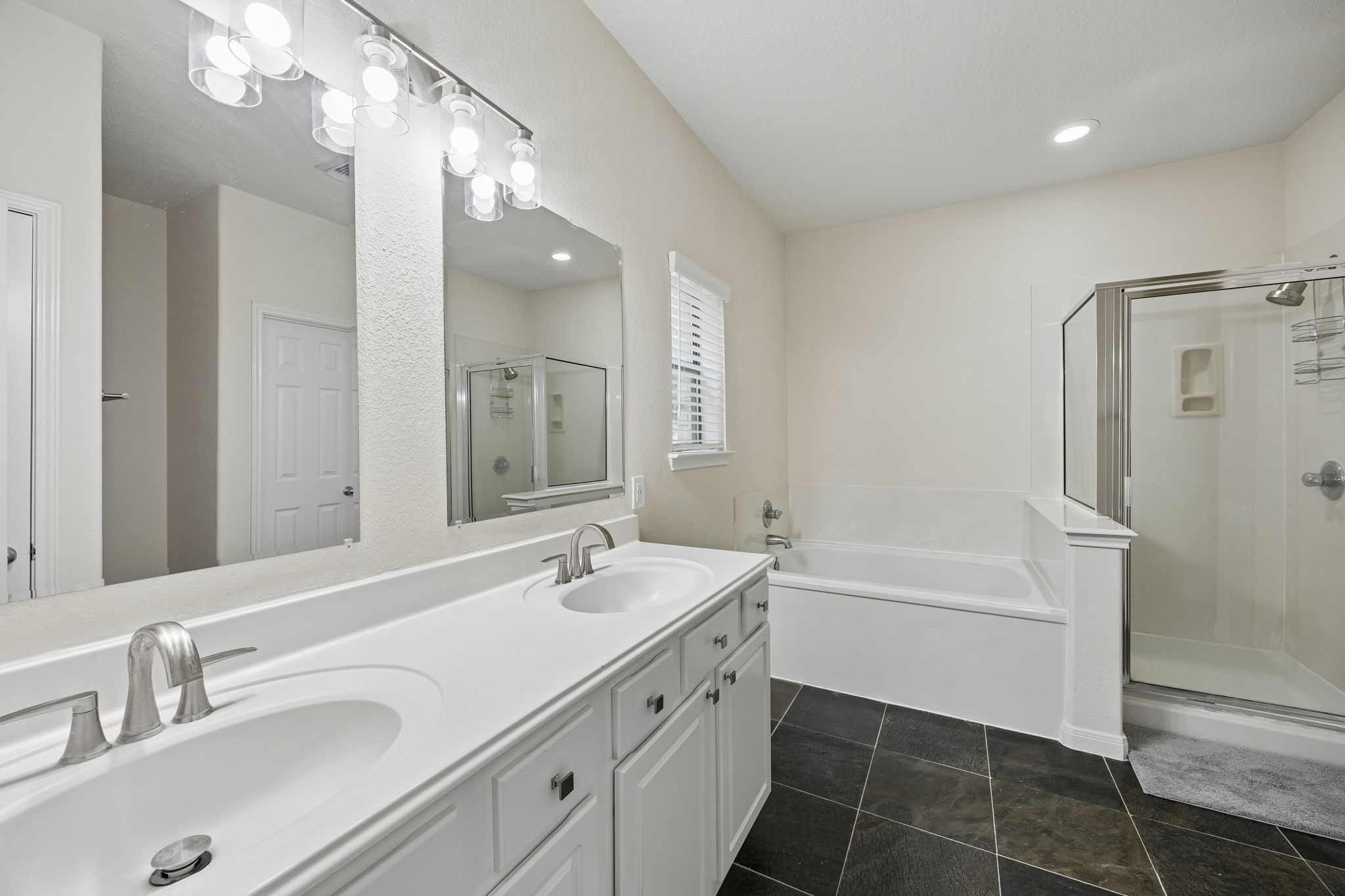 29711 Legends Green Drive Spring, TX 77386 - Photo 11 of 28 a bathroom with a double vanity sink mirror double vanity tub and shower
