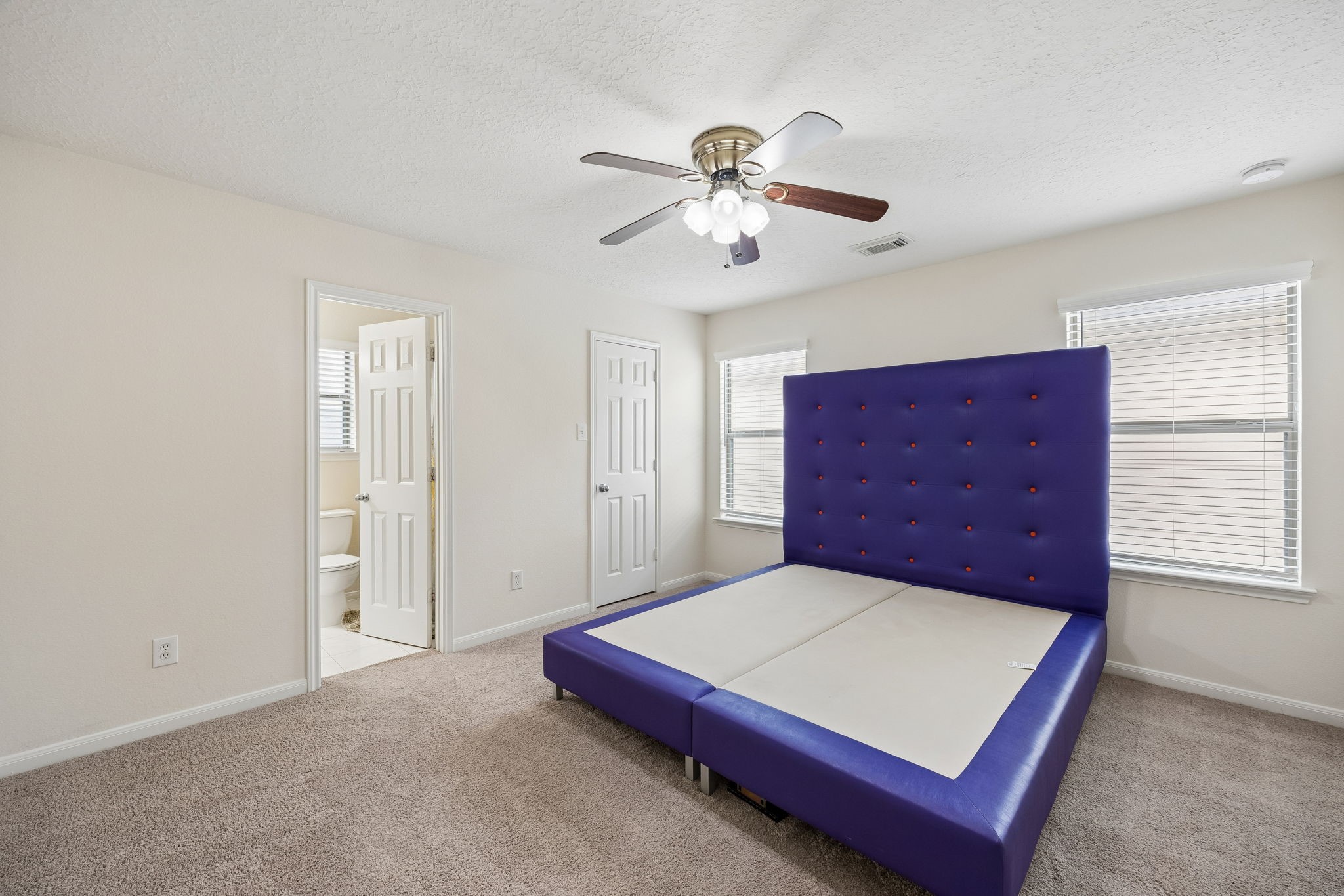 29711 Legends Green Drive Spring, TX 77386 - Photo 15 of 28 a bedroom with a bed and a chandelier
