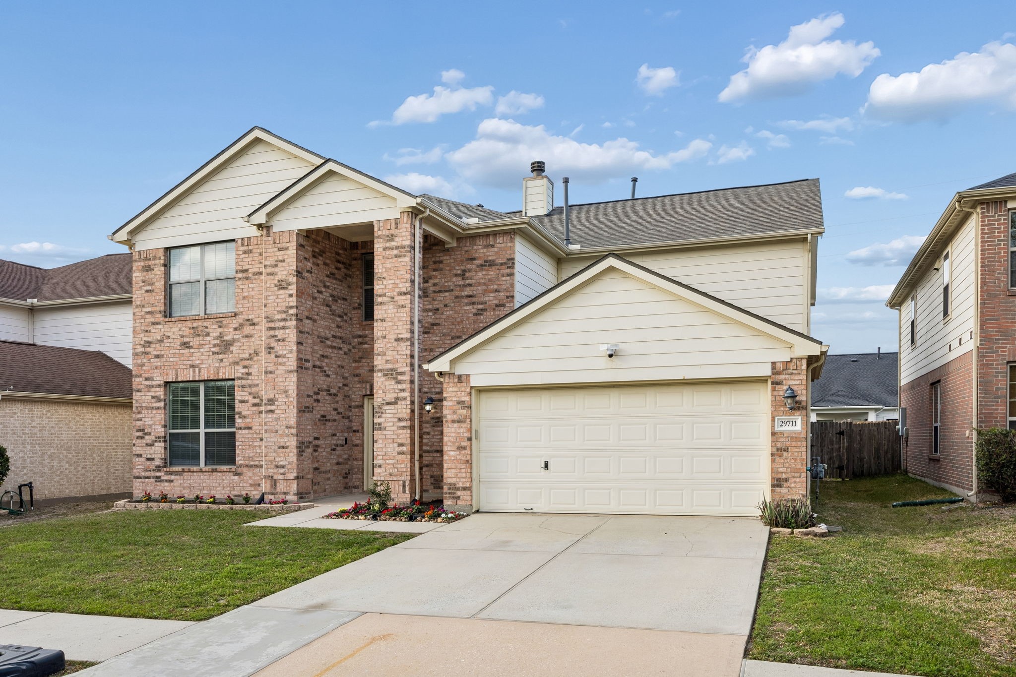 29711 Legends Green Drive Spring, TX 77386 - Photo 25 of 28 a view of a white house next to a yard with big trees