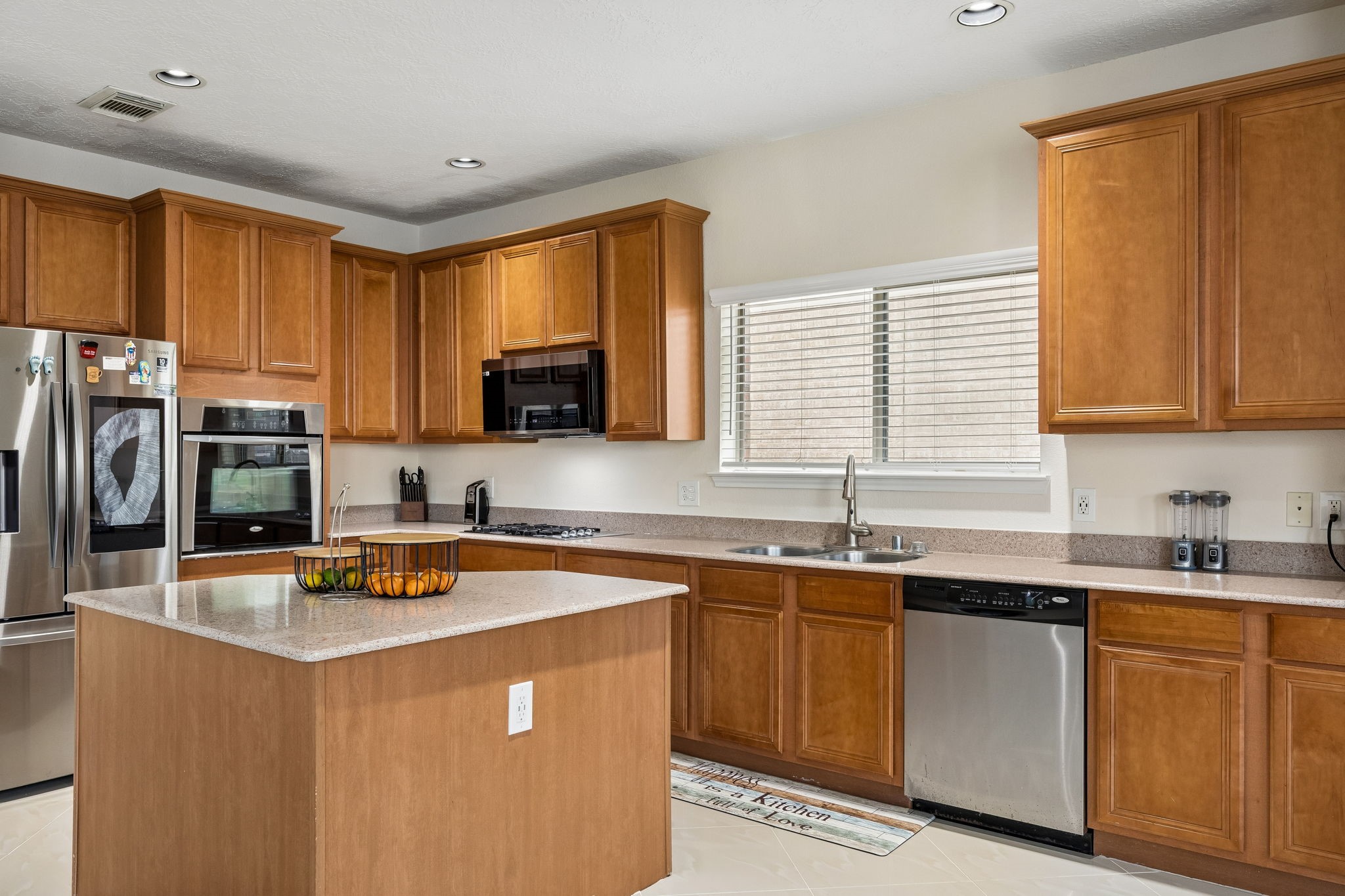 29711 Legends Green Drive Spring, TX 77386 - Photo 7 of 28 a kitchen with stainless steel appliances granite countertop a sink a stove a refrigerator cabinets and a window