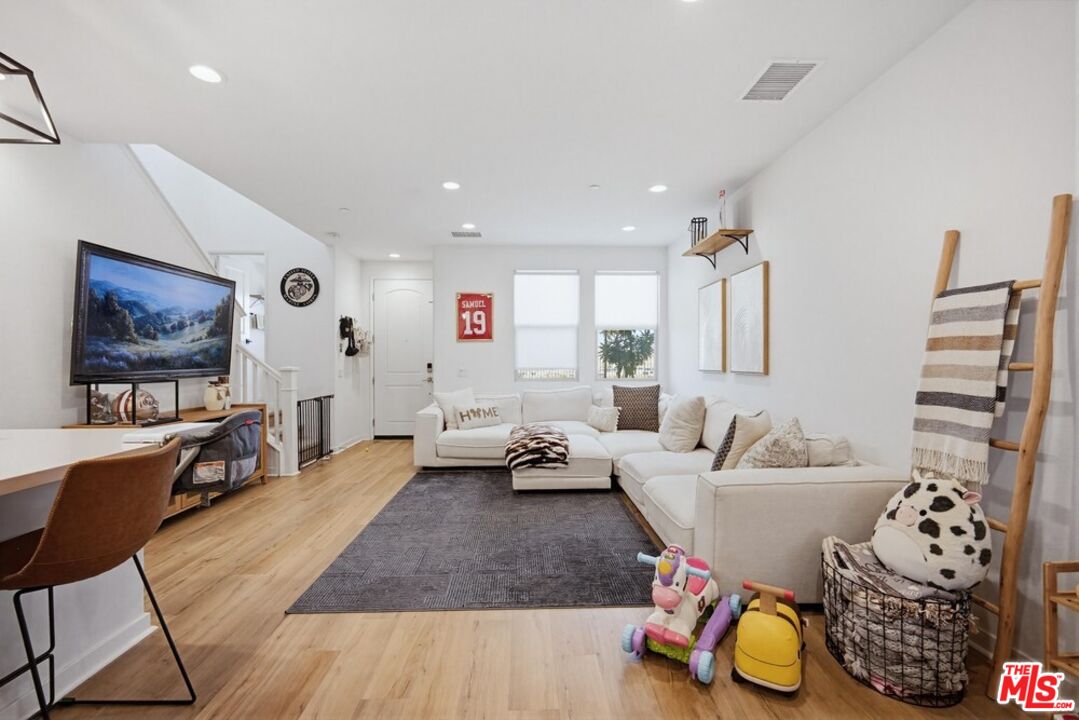 4105 Cameron Way, Unit 103 Corona, CA 92883 - Photo 11 of 30 a living room with furniture and a flat screen tv