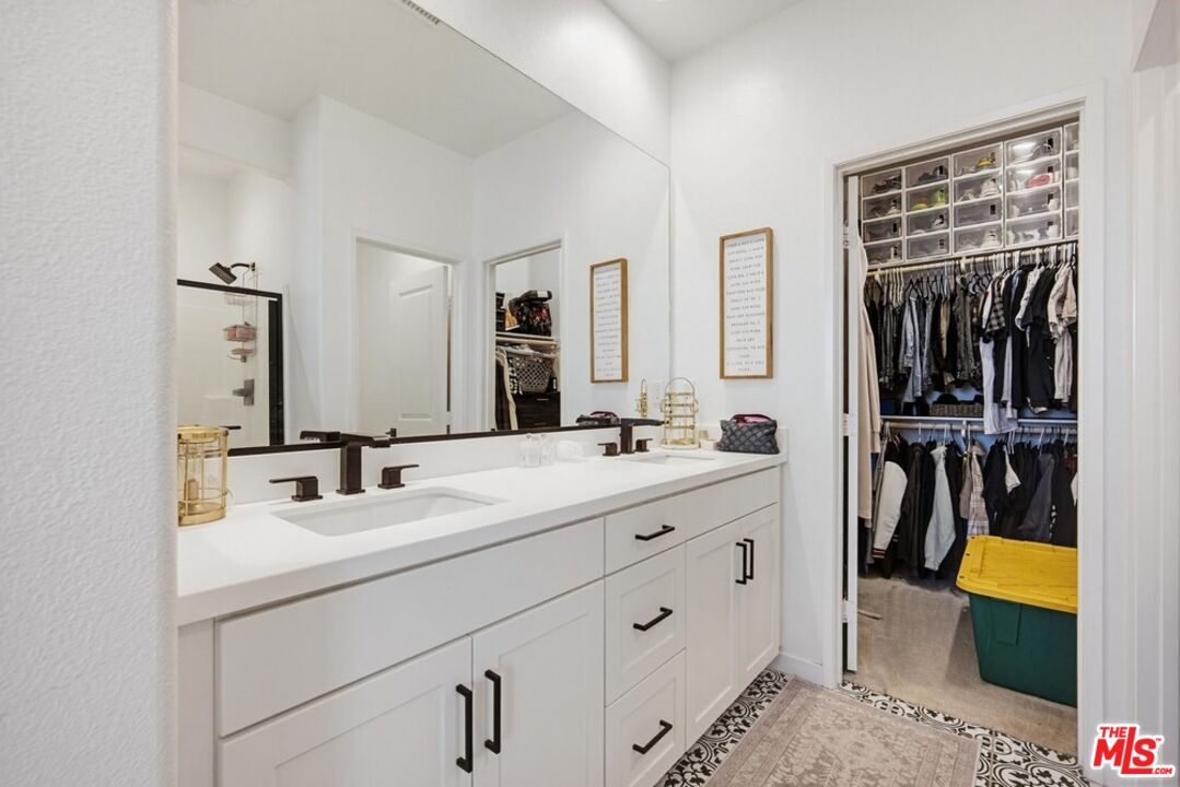 4105 Cameron Way, Unit 103 Corona, CA 92883 - Photo 17 of 30 a bathroom with a double vanity sink and a mirror