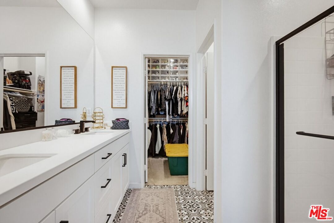 4105 Cameron Way, Unit 103 Corona, CA 92883 - Photo 18 of 30 a bathroom with a double vanity sink and a mirror