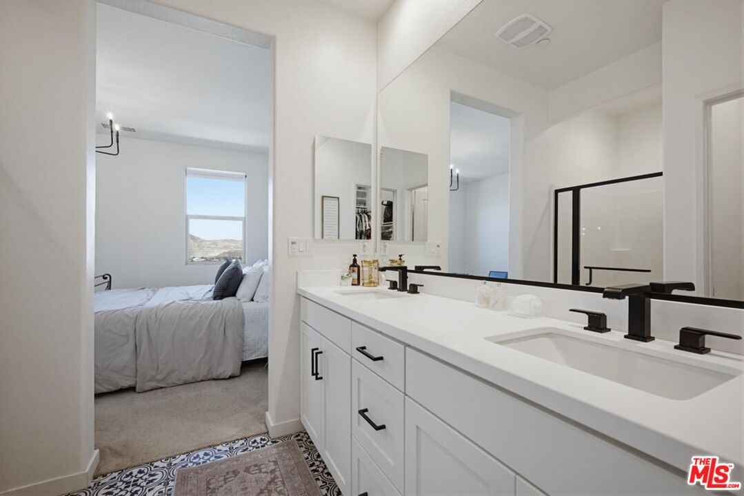 4105 Cameron Way, Unit 103 Corona, CA 92883 - Photo 19 of 30 a en suite bathroom with double sink and a mirror