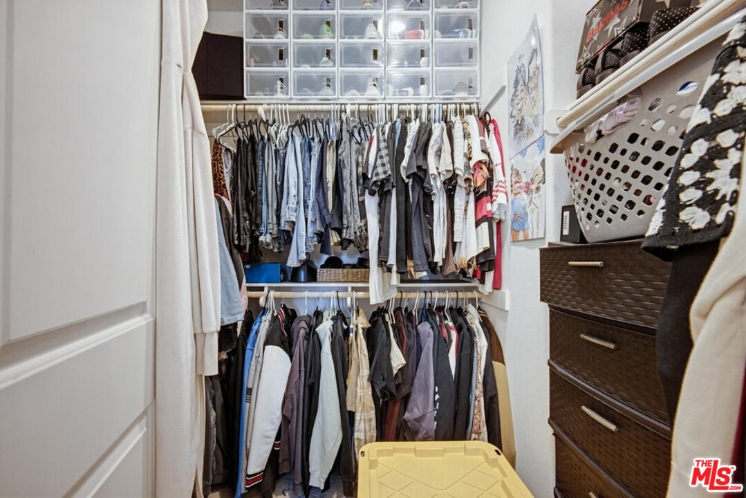 4105 Cameron Way, Unit 103 Corona, CA 92883 - Photo 20 of 30 a view of walk in closet with clothes and shoes