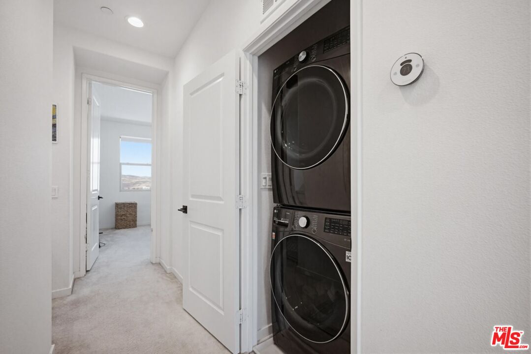 4105 Cameron Way, Unit 103 Corona, CA 92883 - Photo 21 of 30 a view of a hallway with washer and dryer