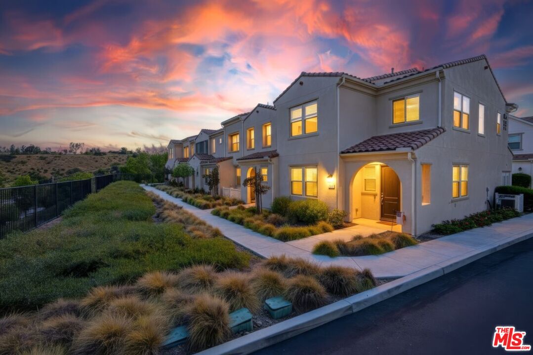 4105 Cameron Way, Unit 103 Corona, CA 92883 - Photo 29 of 30 a front view of a house with a yard