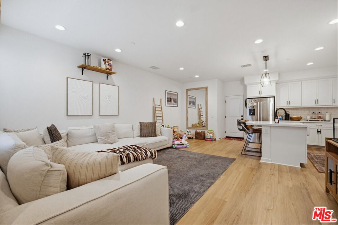 4105 Cameron Way, Unit 103 Corona, CA 92883 - Photo 5 of 30 a living room with furniture and kitchen view