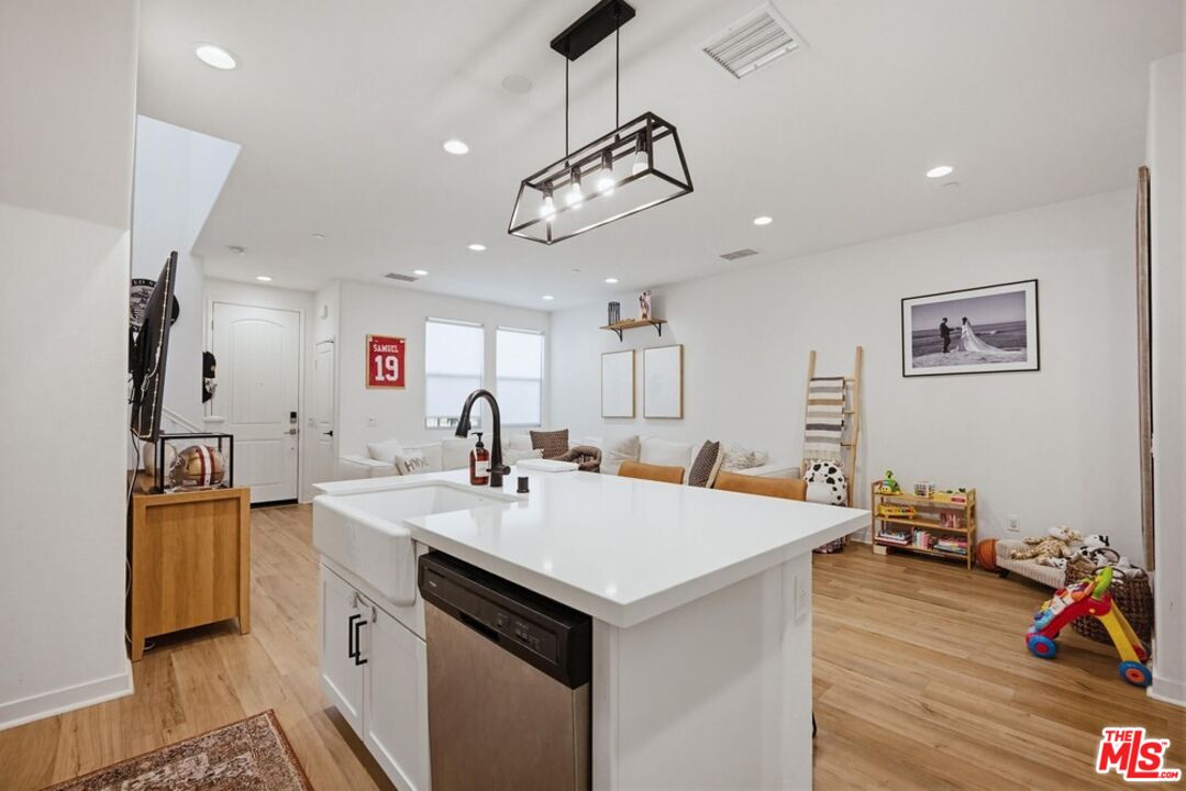 4105 Cameron Way, Unit 103 Corona, CA 92883 - Photo 10 of 30 a view of a kitchen sink appliances and wooden floor