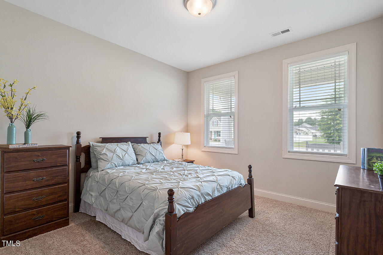 116 Celestial Drive Garner, NC 27529 - Photo 16 of 23 a bedroom with a bed and a window