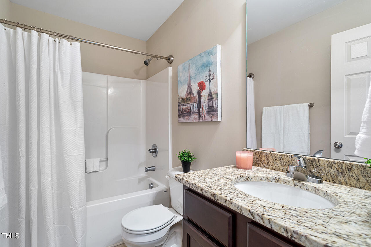 116 Celestial Drive Garner, NC 27529 - Photo 20 of 23 a bathroom with a granite countertop sink toilet and shower