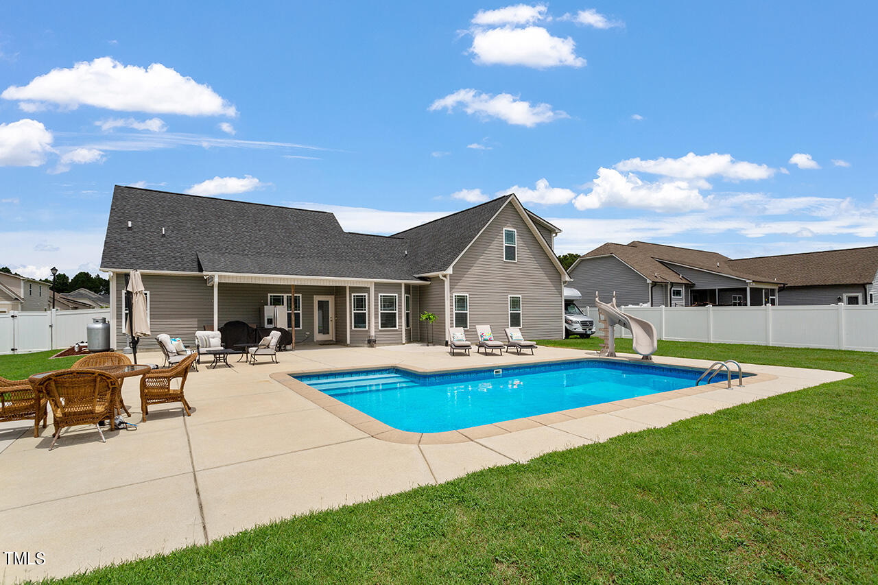 116 Celestial Drive Garner, NC 27529 - Photo 3 of 23 a view of house with swimming pool yard fire pit and outdoor seating