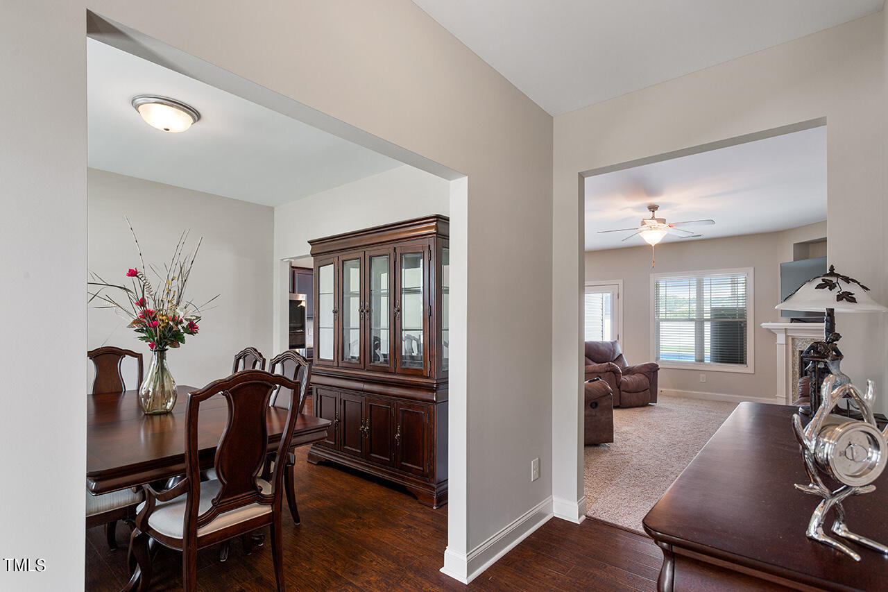 116 Celestial Drive Garner, NC 27529 - Photo 4 of 23 a view of a dining room with furniture and wooden floor