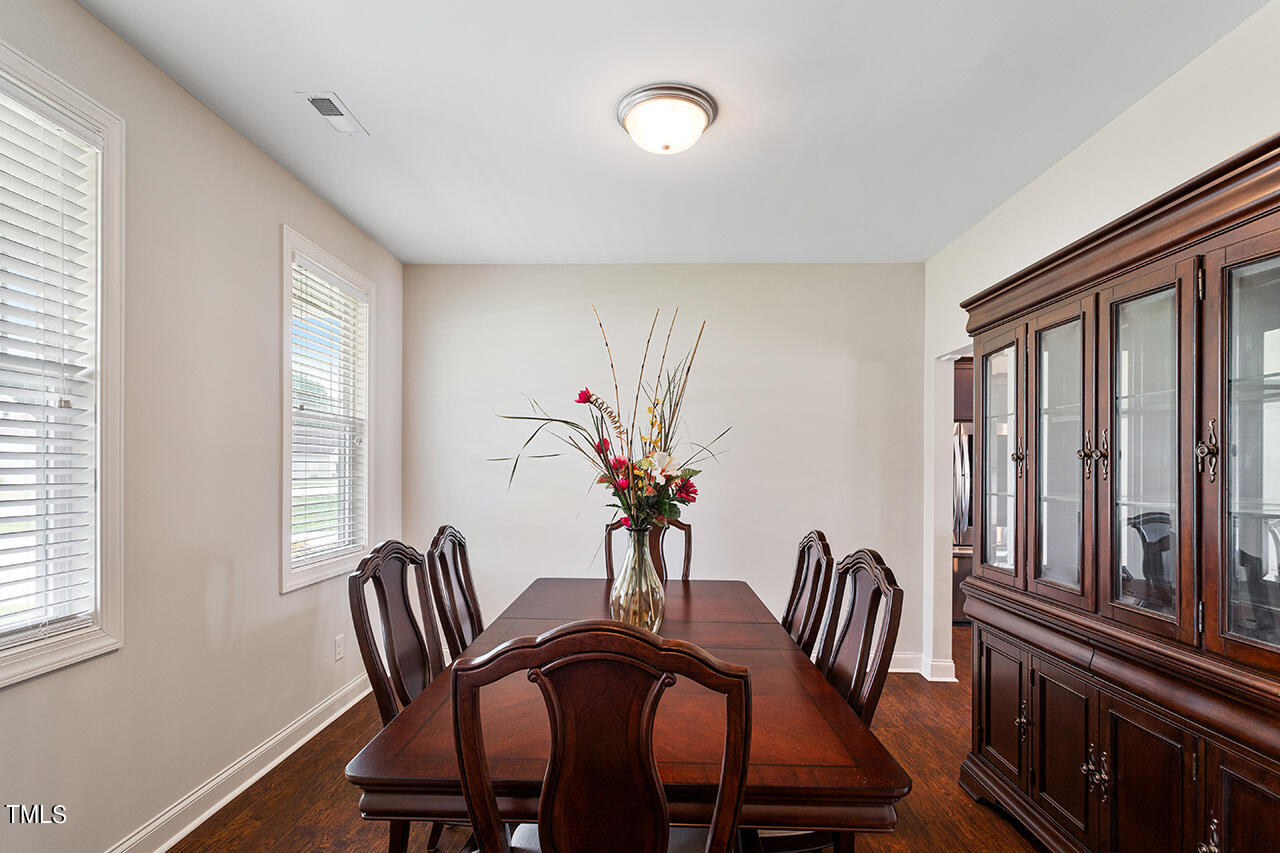 116 Celestial Drive Garner, NC 27529 - Photo 5 of 23 a view of a dining room with furniture window and wooden floor