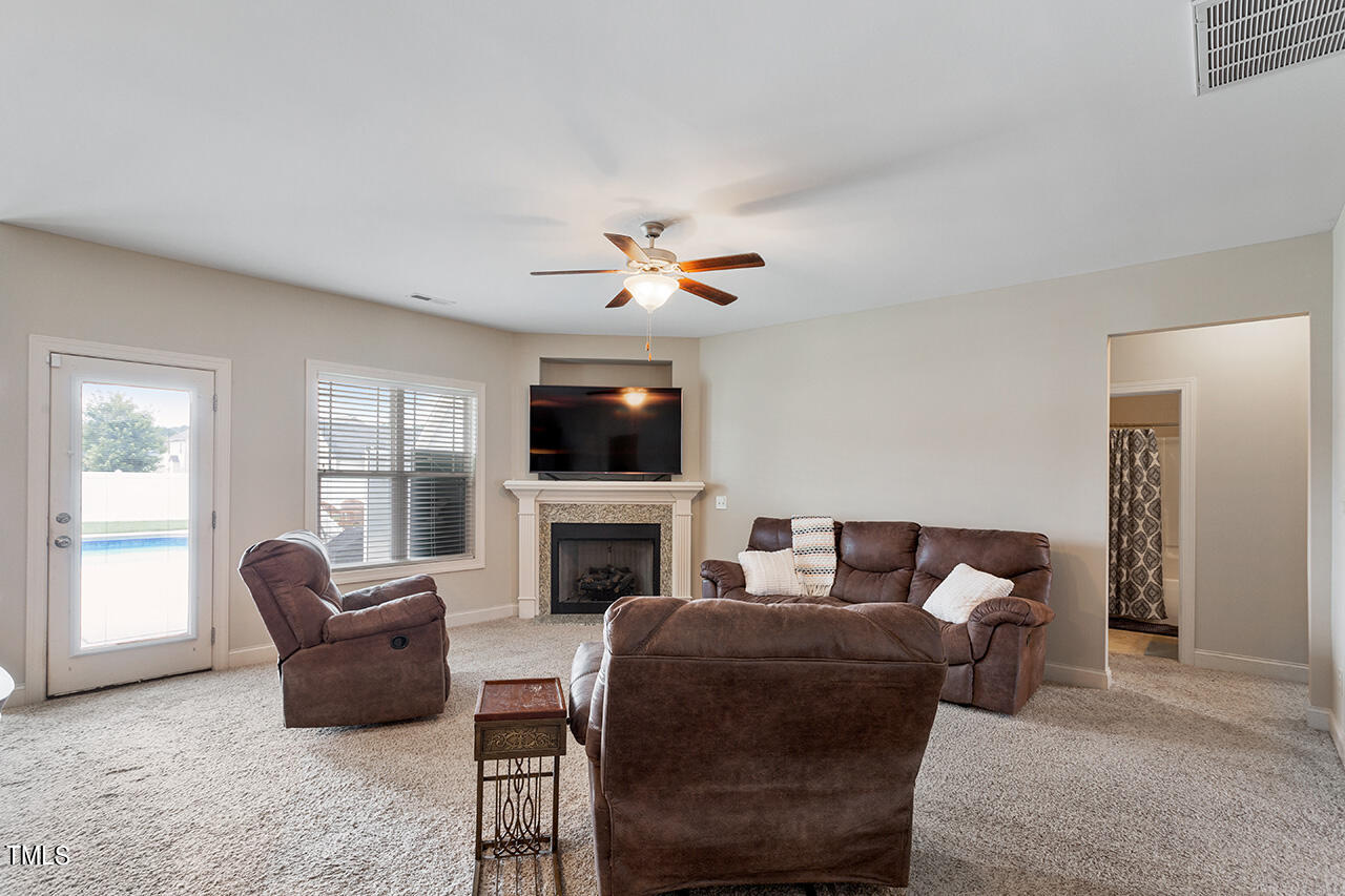 116 Celestial Drive Garner, NC 27529 - Photo 6 of 23 a living room with furniture ceiling fan and a flat screen tv