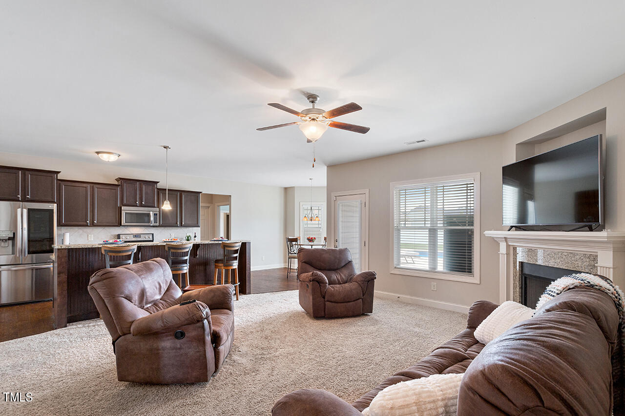 116 Celestial Drive Garner, NC 27529 - Photo 7 of 23 a living room with furniture kitchen view and a flat screen tv