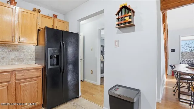 a view of walk in closet with wooden floor and windows