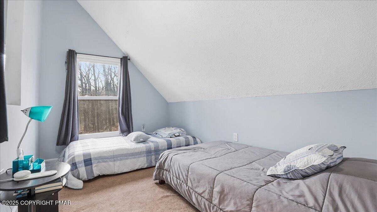 109 Saunders Drive Bushkill, PA 18324 - Photo 24 of 106 a bedroom with two beds and a table