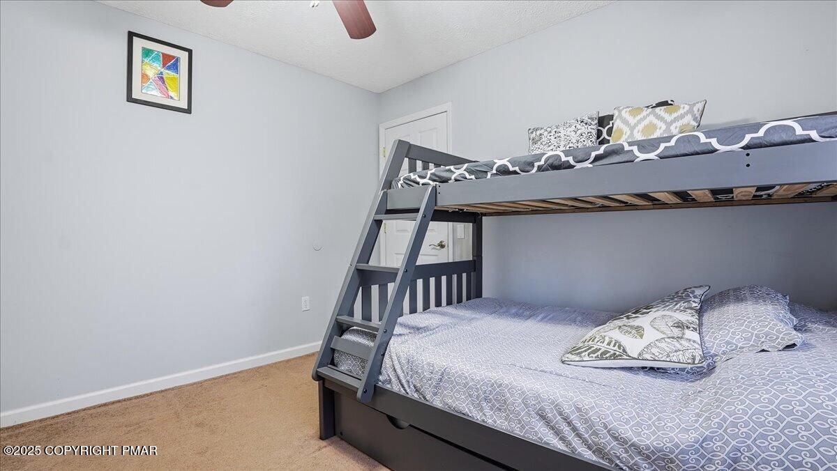 109 Saunders Drive Bushkill, PA 18324 - Photo 25 of 106 a bedroom with a bed and painting on the wall