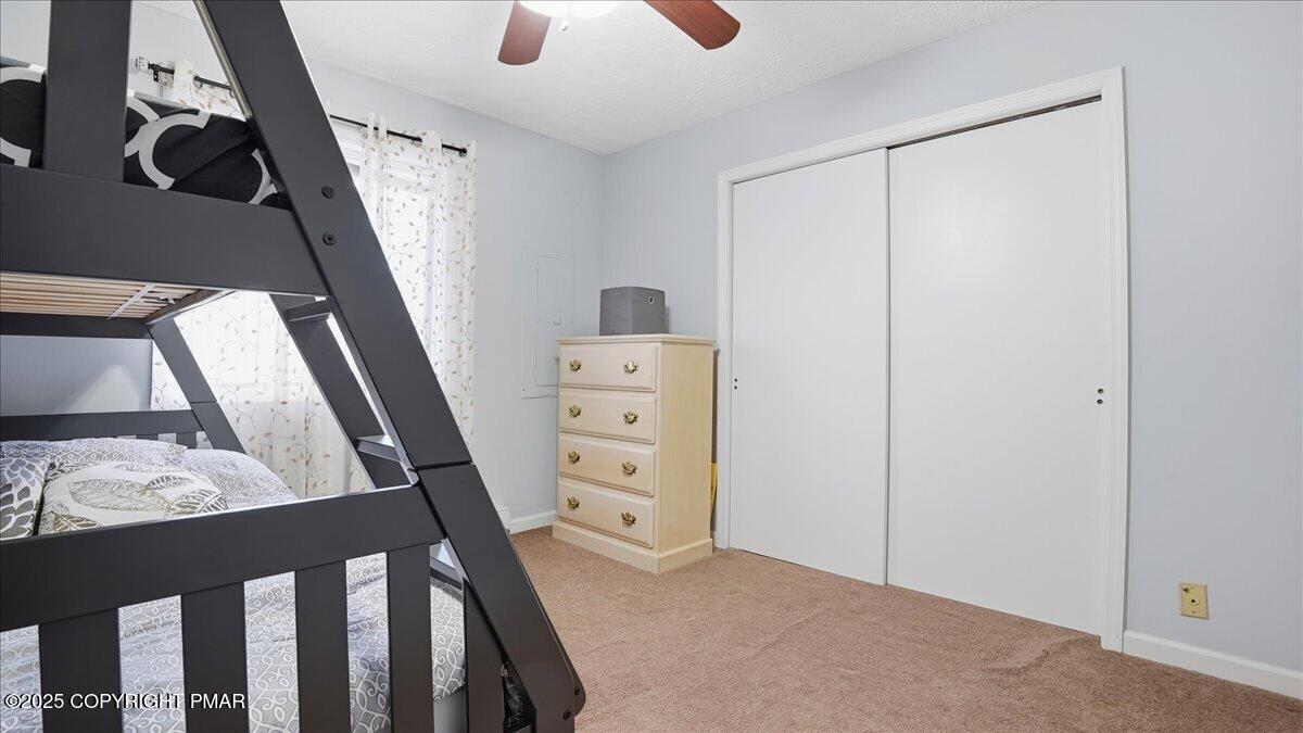 109 Saunders Drive Bushkill, PA 18324 - Photo 27 of 106 a view of walk in closet with wooden floor and windows