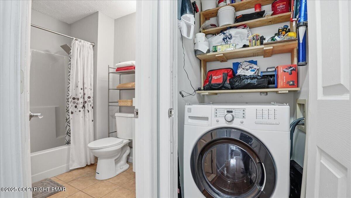 109 Saunders Drive Bushkill, PA 18324 - Photo 36 of 106 a bathroom with a toilet and a shower curtain