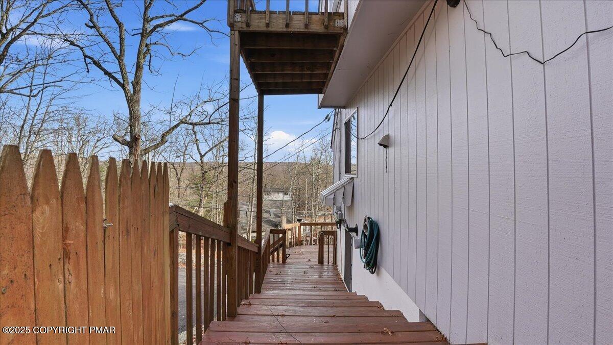 109 Saunders Drive Bushkill, PA 18324 - Photo 53 of 106 a view of a balcony with wooden floor and fence