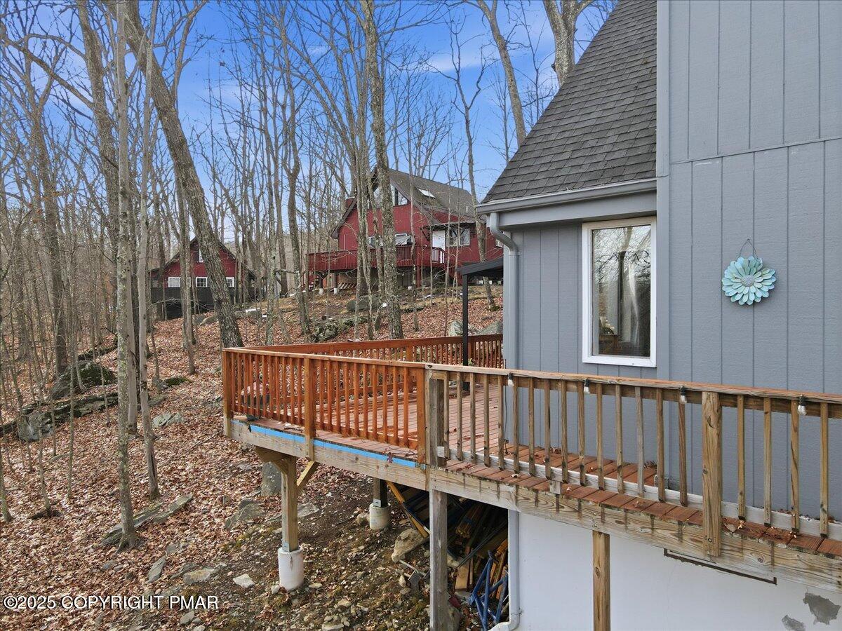 109 Saunders Drive Bushkill, PA 18324 - Photo 55 of 106 a view of a wooden house with large trees and wooden fence
