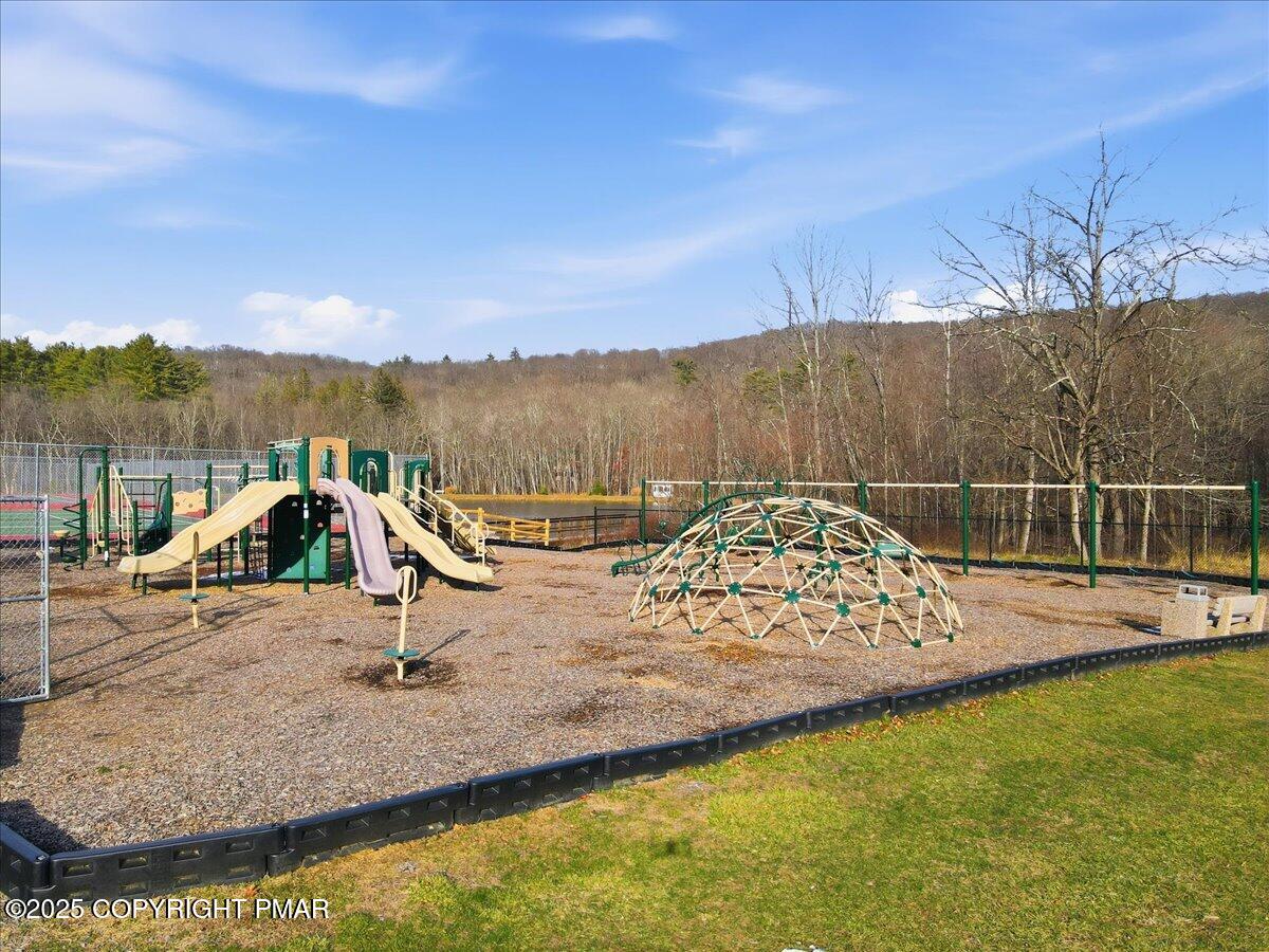 109 Saunders Drive Bushkill, PA 18324 - Photo 82 of 106 a view of a swimming pool with a yard and seating area