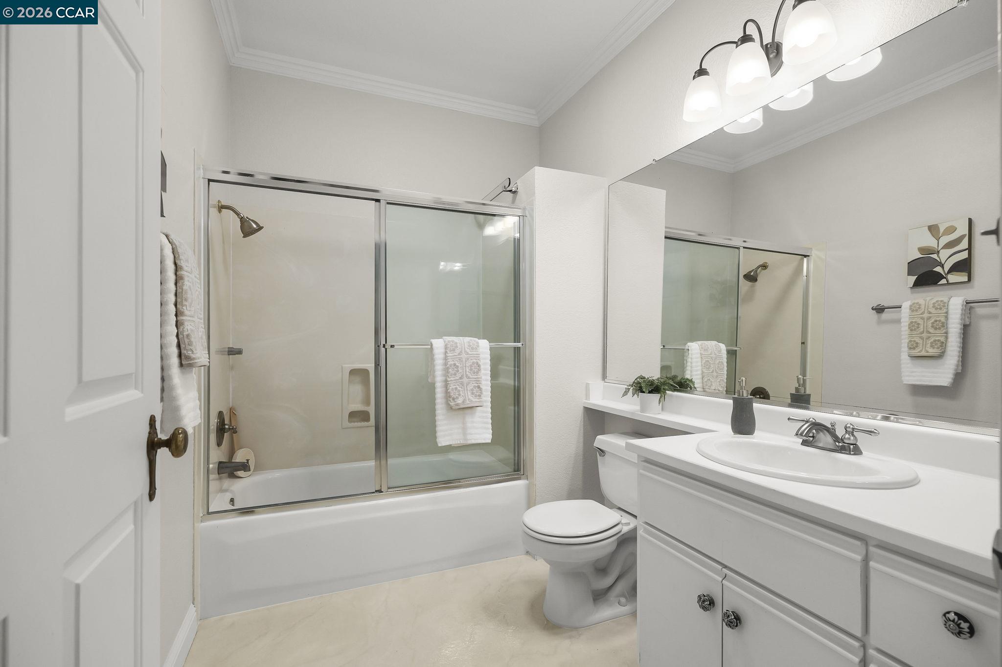 2586 Oak Road, Unit 130 Walnut Creek, CA 94597 - Photo 16 of 31 a bathroom with a sink a toilet and a large mirror