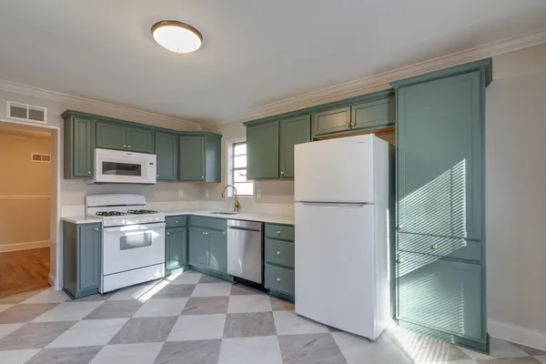 a kitchen with stainless steel appliances granite countertop a refrigerator sink and stove