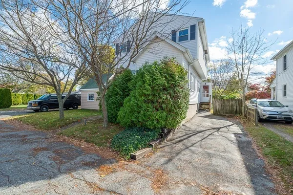 a view of a house with a yard and pathway
