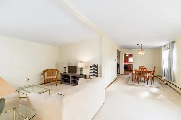 a living room with furniture a dining table and a workspace