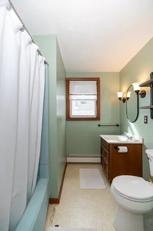 a room with a sink a toilet and tub